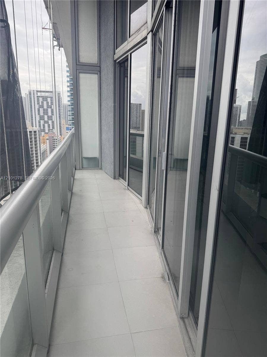 485 Brickell Avenue, #2806, Miami, Miami, FL 33131 Private balcony featuring expansive floor-to-ceiling glass paneling, tile flooring, and a sleek metal railing