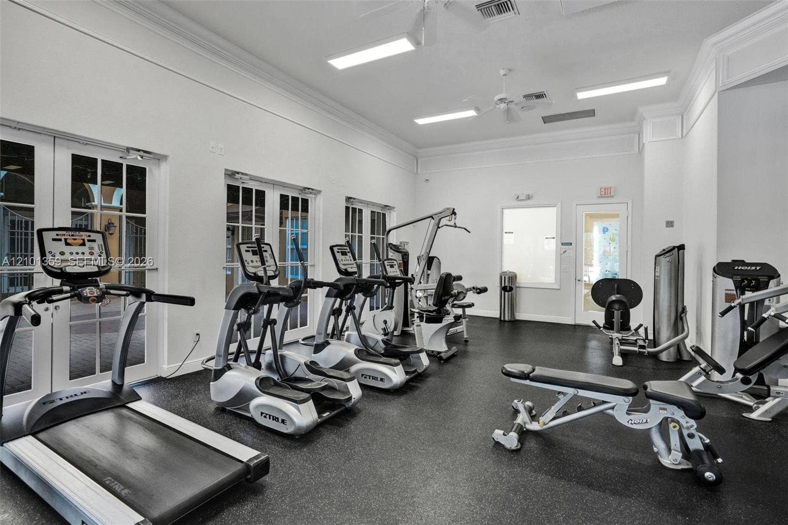 859 SW 147th Terrace, #0, Pembroke Pines, FL 33027 Fitness facility featuring high ceilings with crown molding, recessed lighting, rubberized flooring, and multiple glass-paned double doors