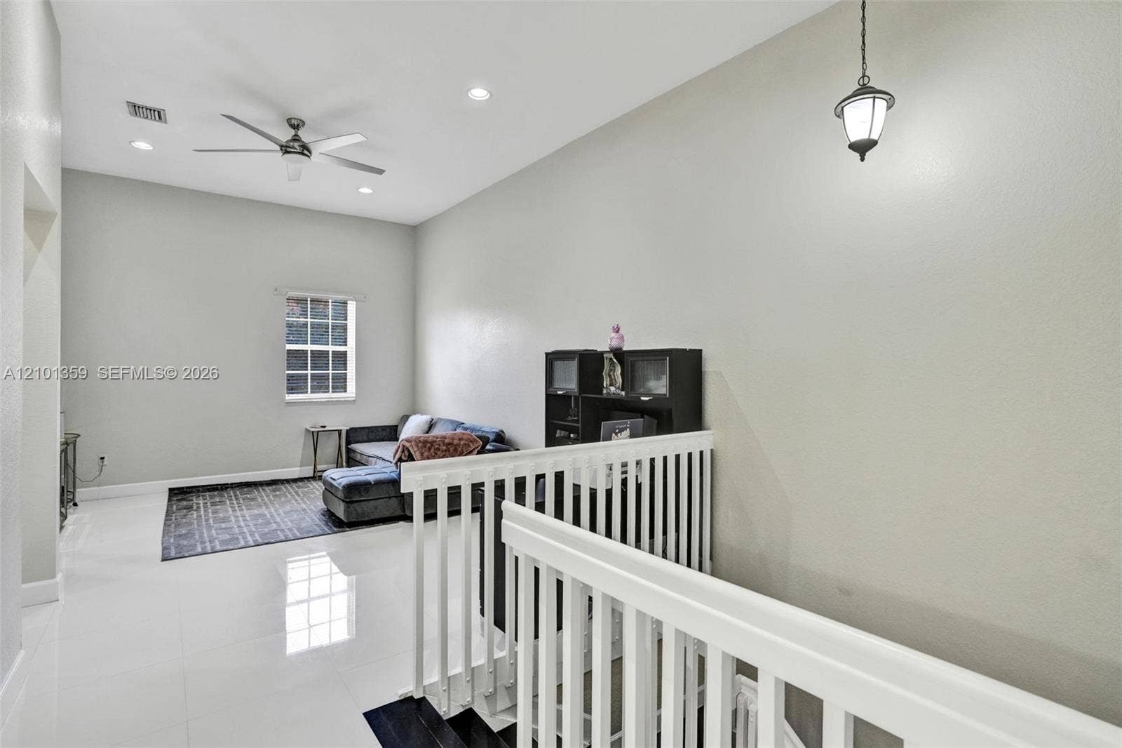 859 SW 147th Terrace, #0, Pembroke Pines, FL 33027 High-ceiling interior featuring polished tile flooring, recessed lighting, a multi-blade ceiling fan, and a white baluster staircase railing