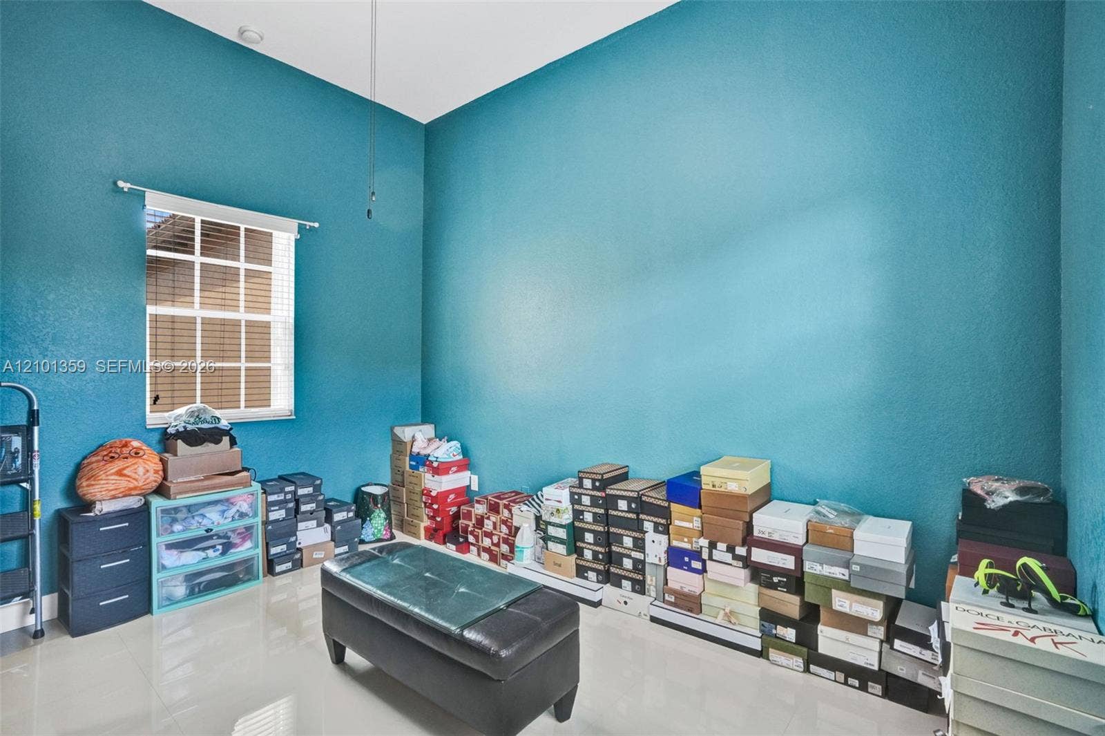 859 SW 147th Terrace, #0, Pembroke Pines, FL 33027 High-ceilinged room featuring a single-hung window with a grid pattern and polished tile flooring