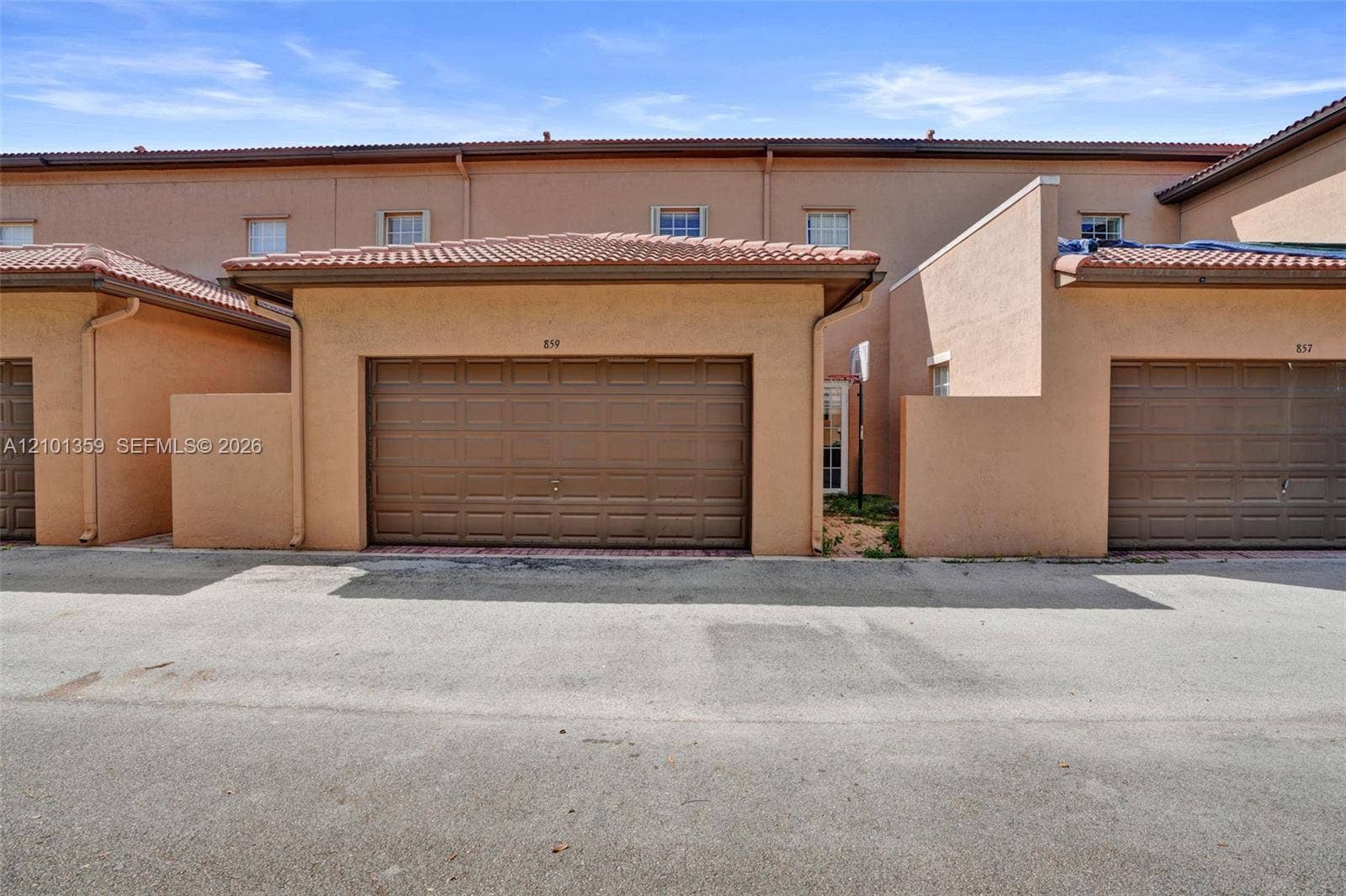 859 SW 147th Terrace, #0, Pembroke Pines, FL 33027 Stucco exterior with mission-style tile roofing and attached single-car garage featuring a paneled door