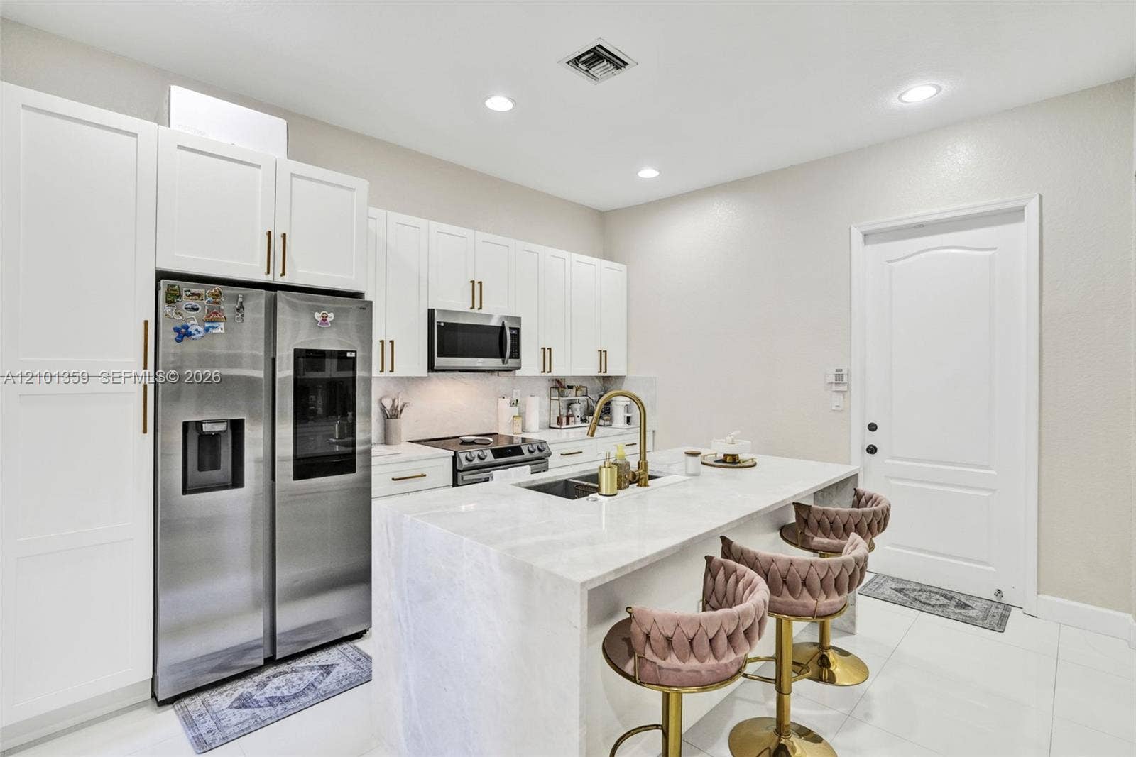 859 SW 147th Terrace, #0, Pembroke Pines, FL 33027 Kitchen featuring white shaker-style cabinetry, a stone-surfaced waterfall island, stainless steel appliances, brass-toned hardware, and recessed lighting