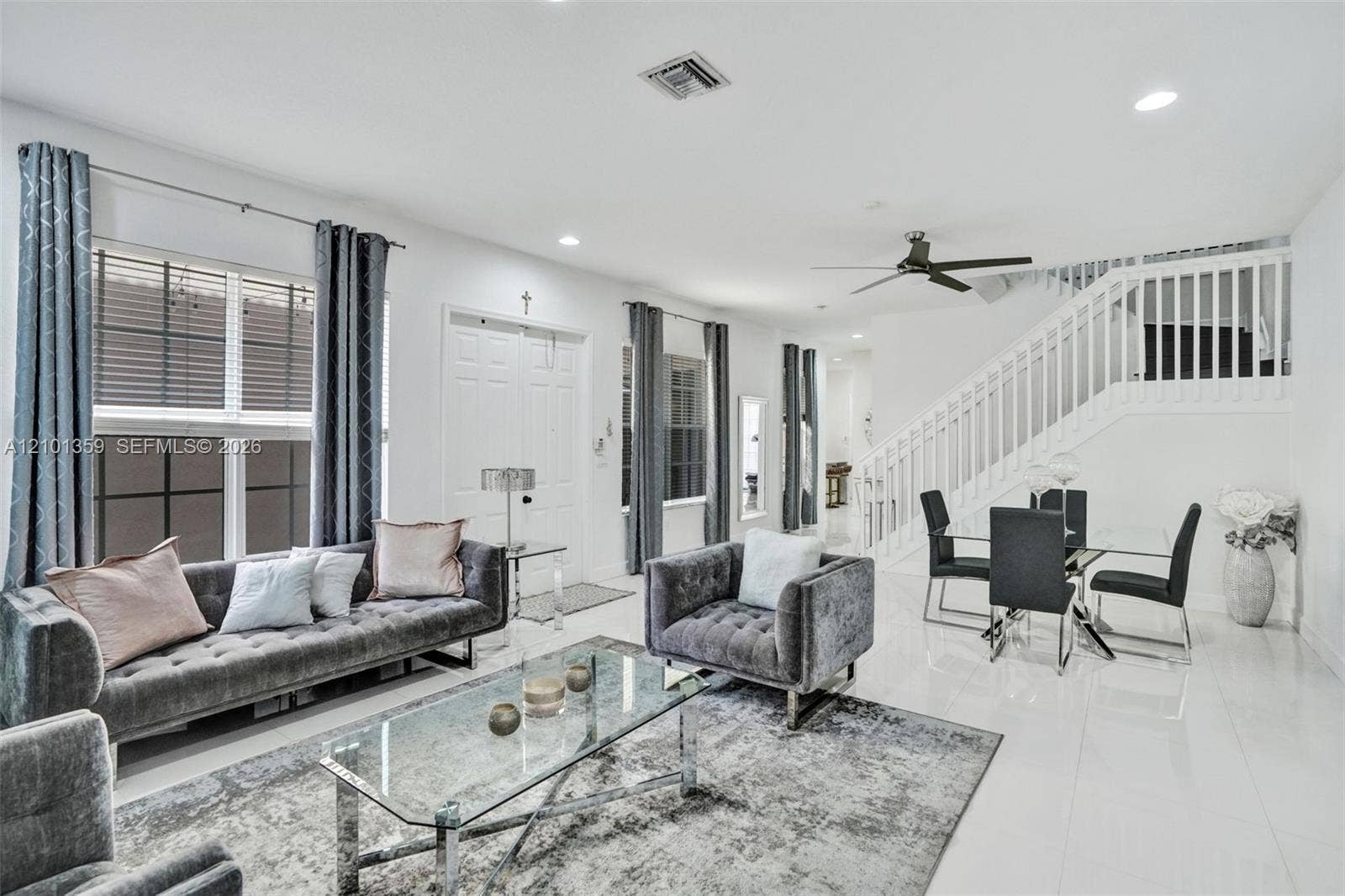 859 SW 147th Terrace, #0, Pembroke Pines, FL 33027 Open-concept living space featuring high-gloss tile flooring, recessed lighting, white stair railing with balusters, and a ceiling fan