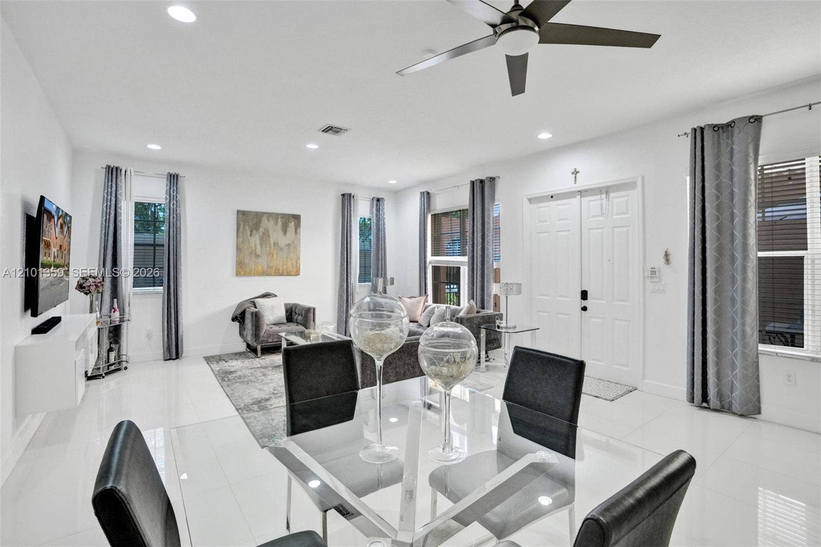 859 SW 147th Terrace, #0, Pembroke Pines, FL 33027 Open-concept living space featuring high ceilings, polished tile flooring, recessed lighting, and a modern ceiling fan