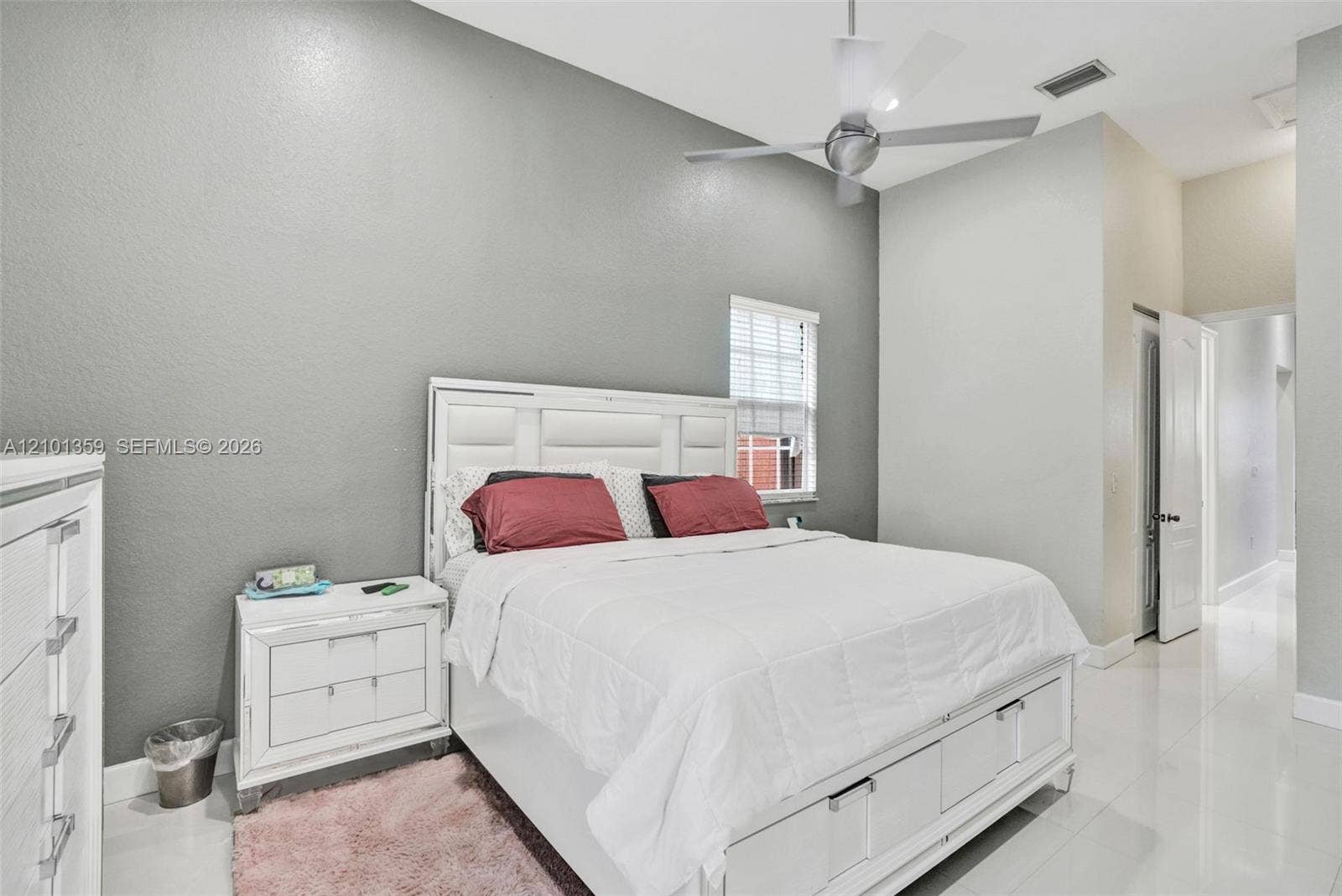 859 SW 147th Terrace, #0, Pembroke Pines, FL 33027 High-ceilinged room with light-toned tile flooring, neutral wall finish, and a ceiling-mounted fan
