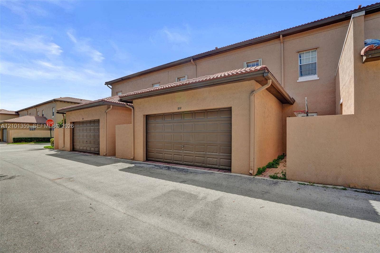 859 SW 147th Terrace, #0, Pembroke Pines, FL 33027 Stucco exterior featuring dual-bay garages with paneled sectional doors and tile roofing