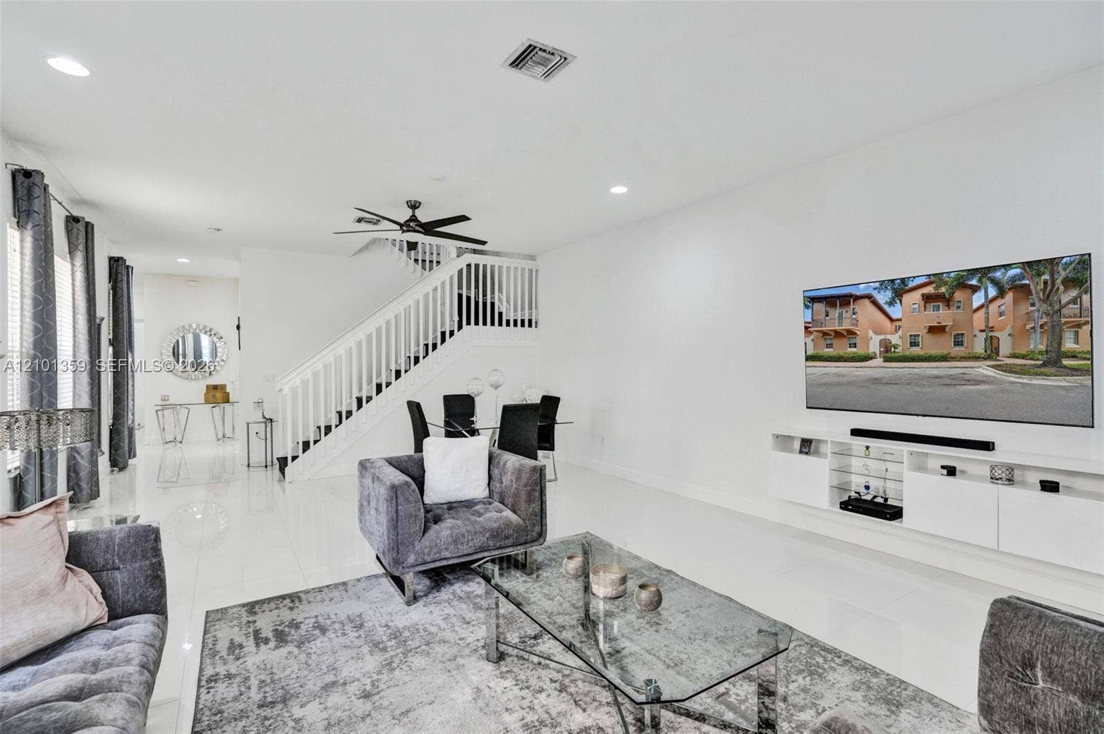 859 SW 147th Terrace, #0, Pembroke Pines, FL 33027 Living area featuring polished tile flooring, recessed lighting, a ceiling fan, a staircase with a white railing, and wall-mounted cabinetry