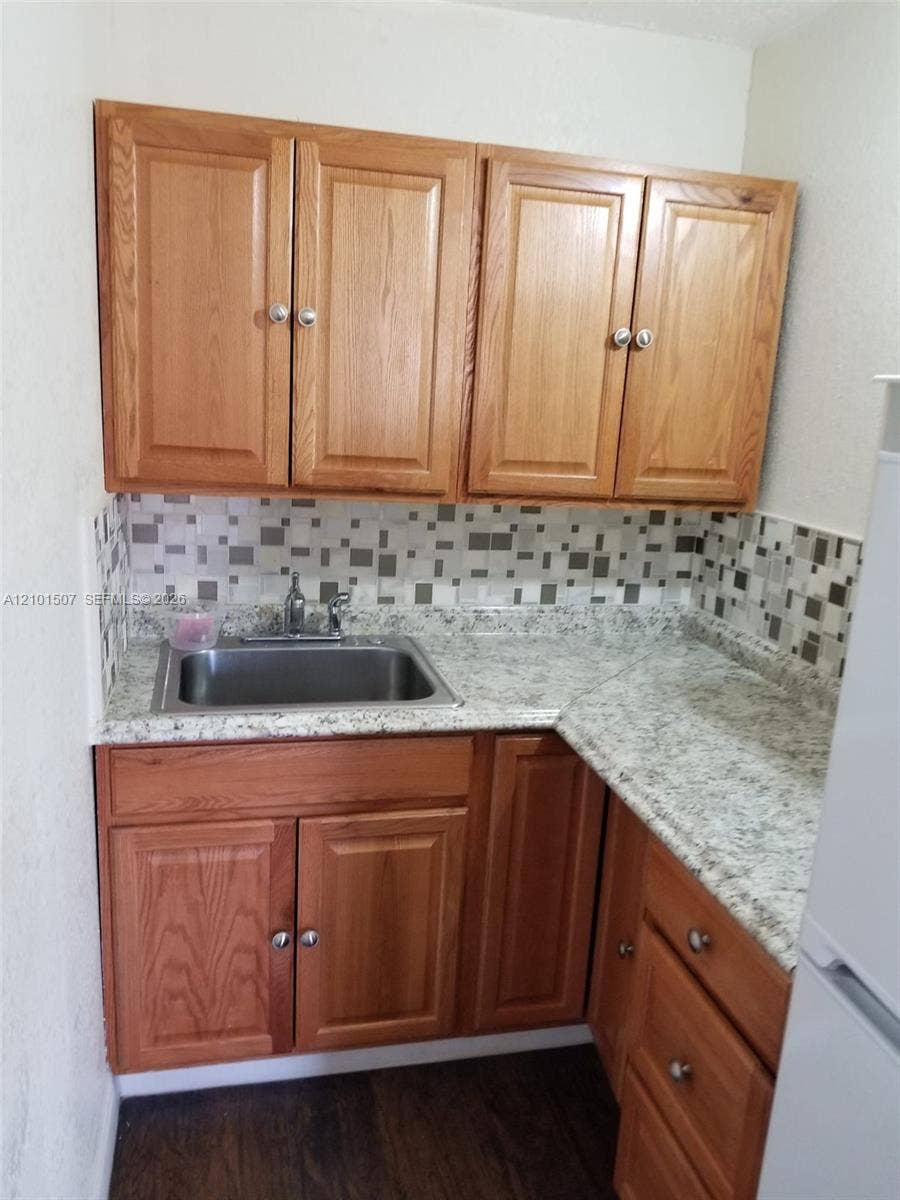 8960 Sunset Strip, Sunrise, FL 33322 Dark-floor space - sink and cabinetry