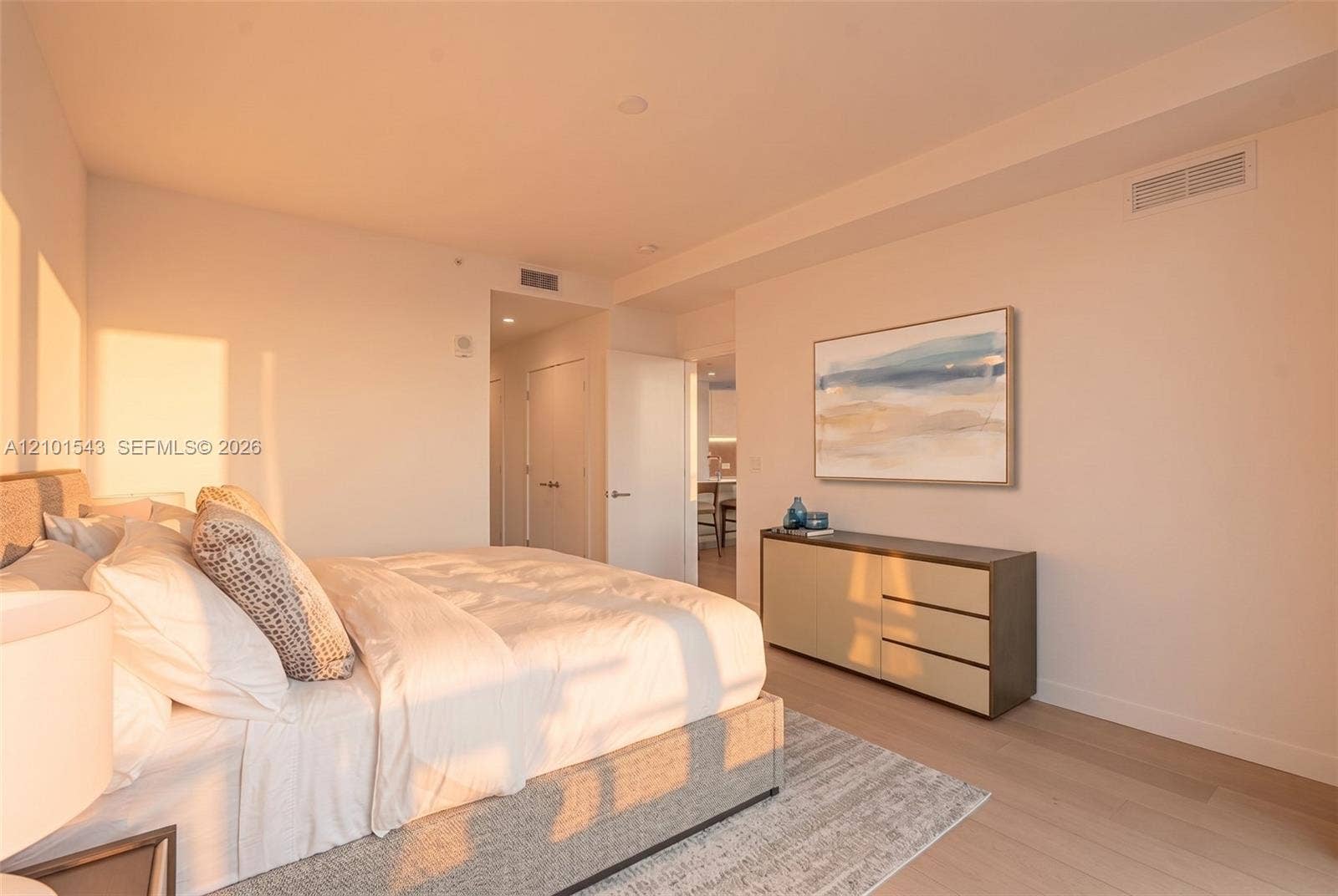 Neutral-toned interior featuring wood-finish flooring, recessed lighting, and crisp wall finishes