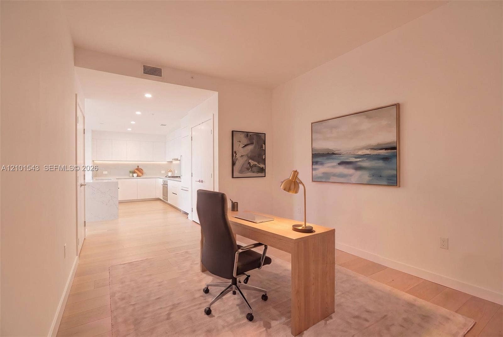 Light-toned wood-finish flooring, white flat-panel cabinetry, quartz countertops, and recessed ceiling lighting