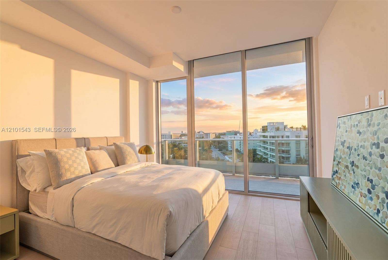 Floor-to-ceiling windows, private balcony, wood-finish flooring, and minimalist architectural lines