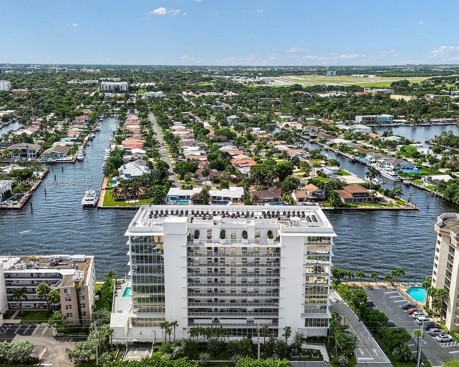 407 N Riverside Drive, #604, Pompano Beach, Pompano Beach, FL 33062 Aerial perspective of a multi-story building featuring floor-to-ceiling windows, private balconies, a flat roofline, and water frontage