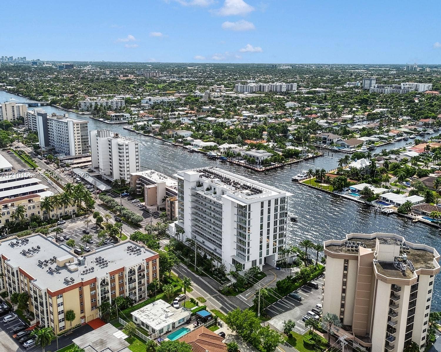 407 N Riverside Drive, #604, Pompano Beach, Pompano Beach, FL 33062 Aerial perspective of a high-rise residential structure positioned along a deep-water canal, featuring expansive balconies, concrete building construction, and proximity to regional waterways