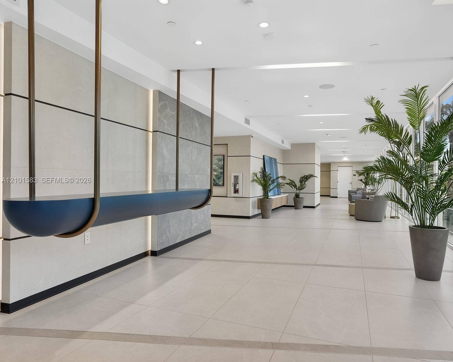 407 N Riverside Drive, #604, Pompano Beach, Pompano Beach, FL 33062 Common area featuring large-format tile flooring, recessed ceiling lighting, and walls accented with stone paneling and integrated vertical lighting