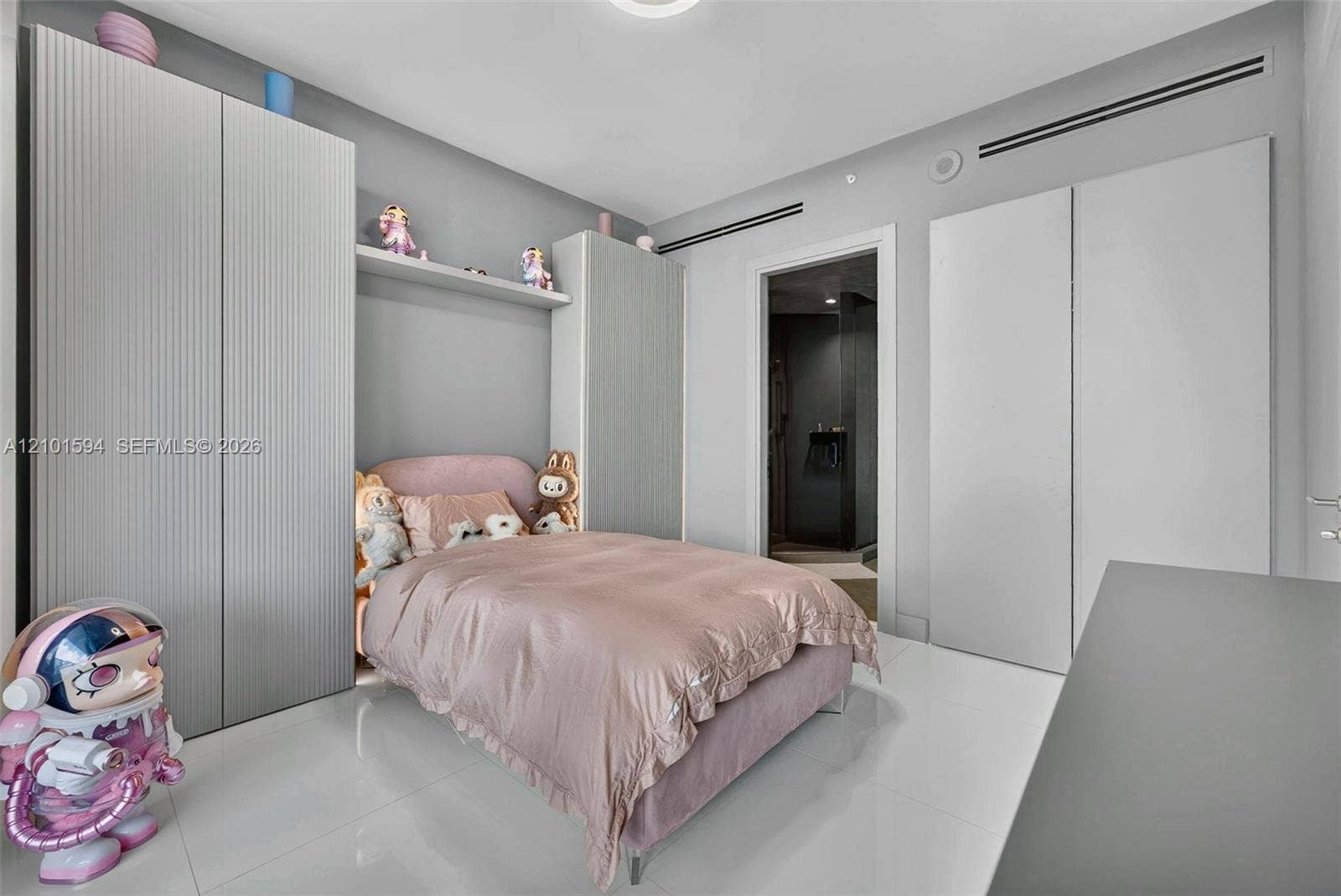 Secondary bedroom with built-in storage and a clean modern design.
