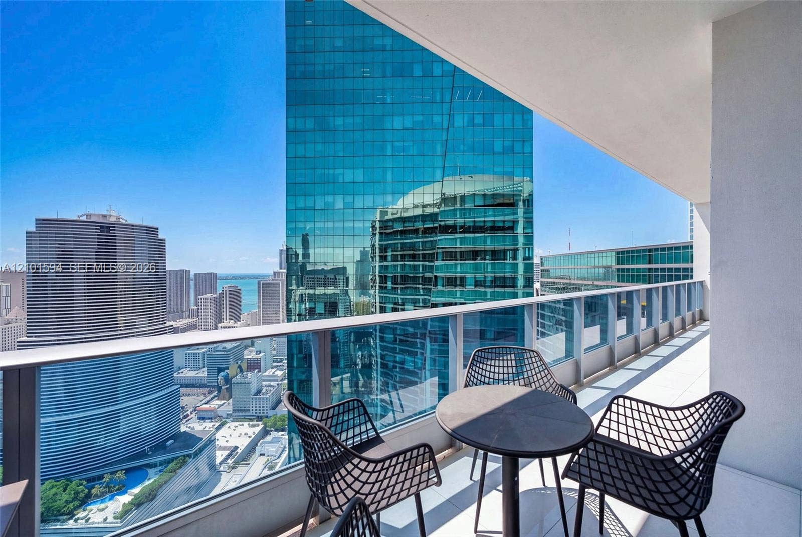 Private balcony with outdoor seating and sweeping Miami skyline views.