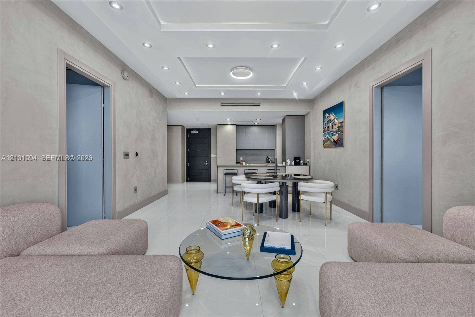 Living room open to the dining area and kitchen, with modern finishes.