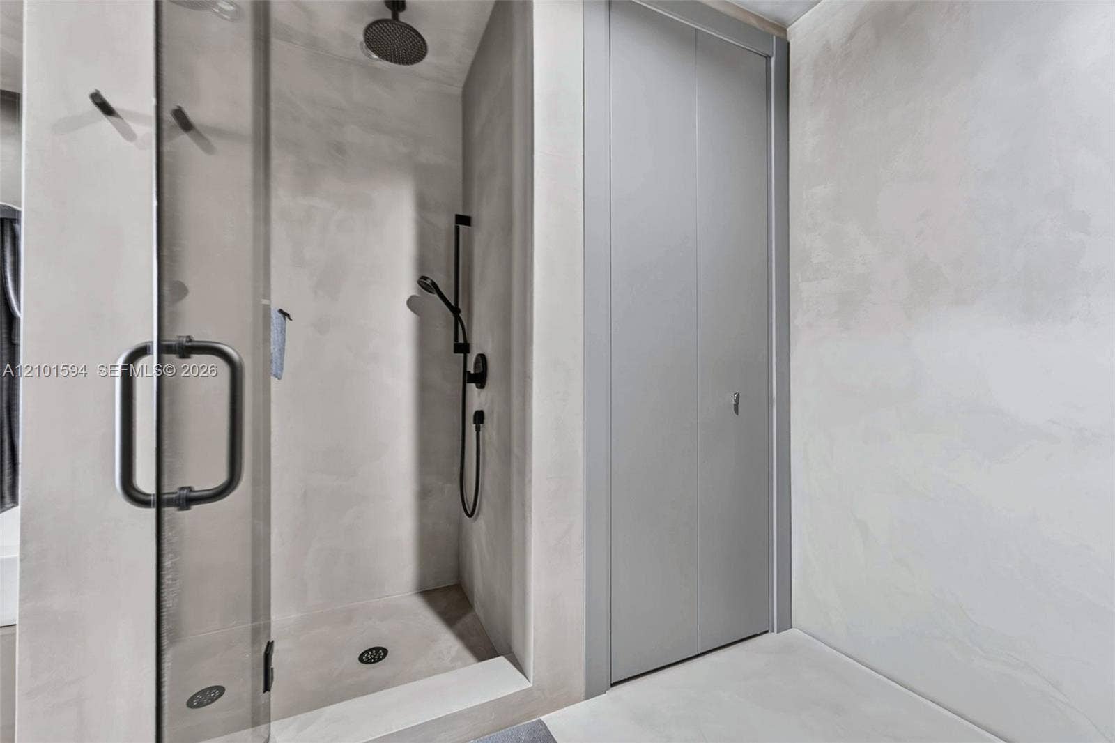 Bathroom with glass-enclosed shower and Hansgrohe thermostatic fixtures.