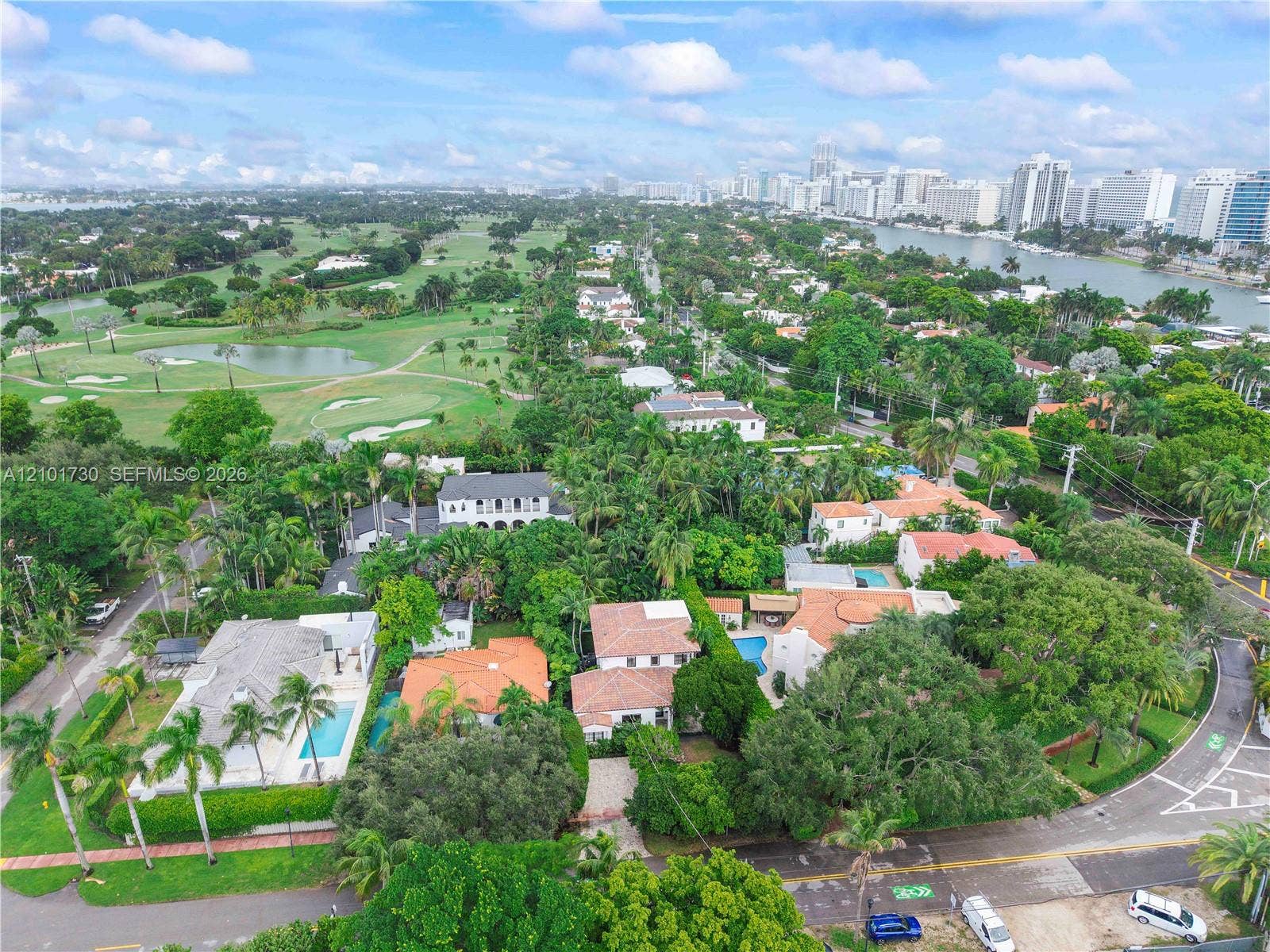 435 W 51st Street, Miami Beach, FL 33140 Aerial perspective featuring lush tropical landscaping, proximity to the waterfront, and expansive golf course grounds
