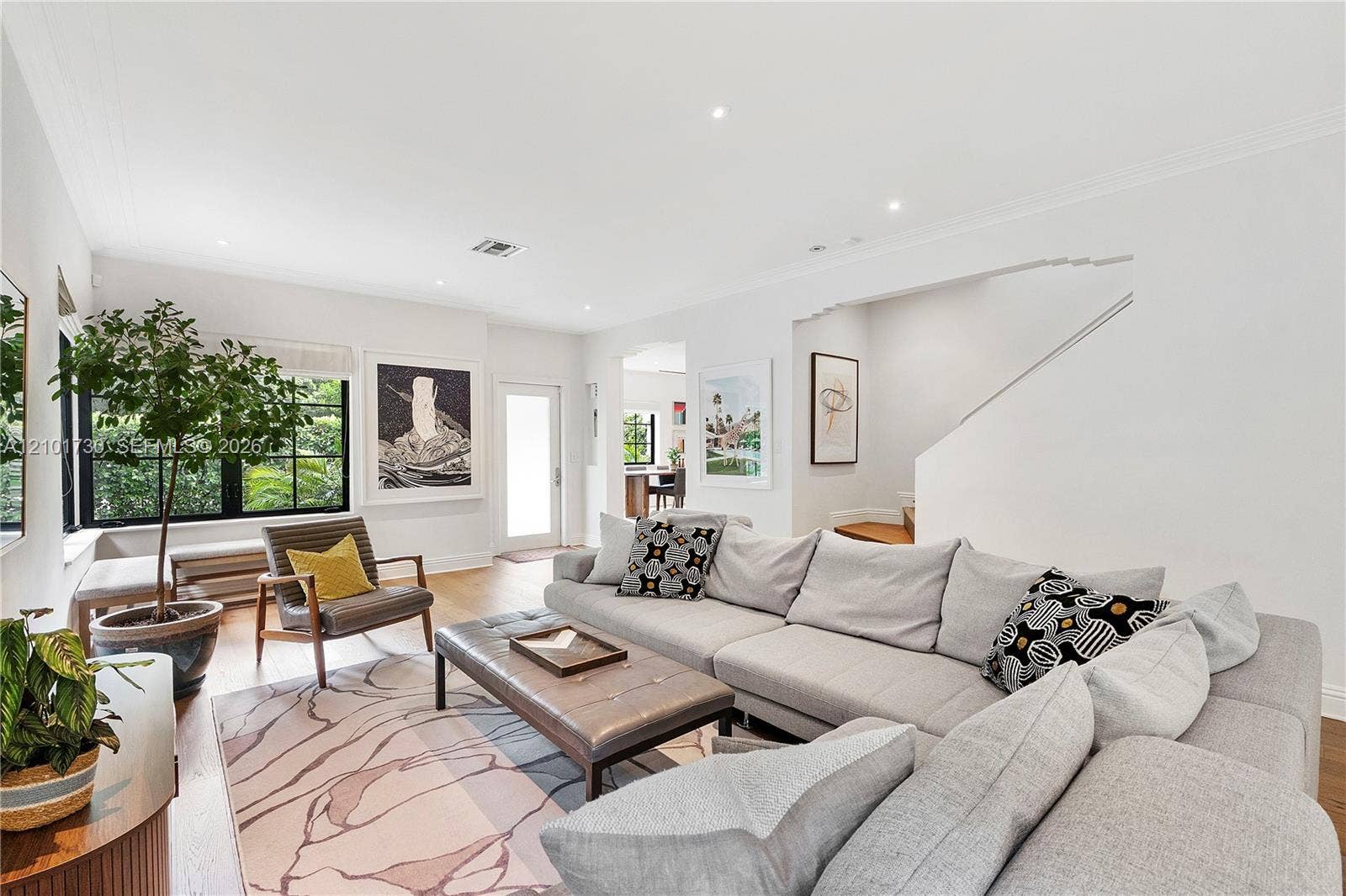 435 W 51st Street, Miami Beach, FL 33140 Living area featuring wood-finish flooring, recessed lighting, crown molding, and black-trimmed multi-pane windows
