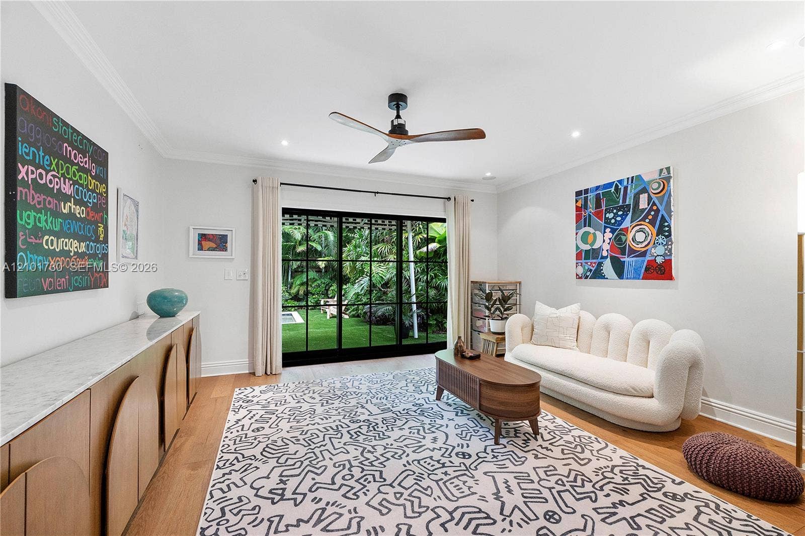 435 W 51st Street, Miami Beach, FL 33140 Living area featuring wood-finish flooring, recessed lighting, crown molding, a ceiling fan, and black-framed sliding glass doors