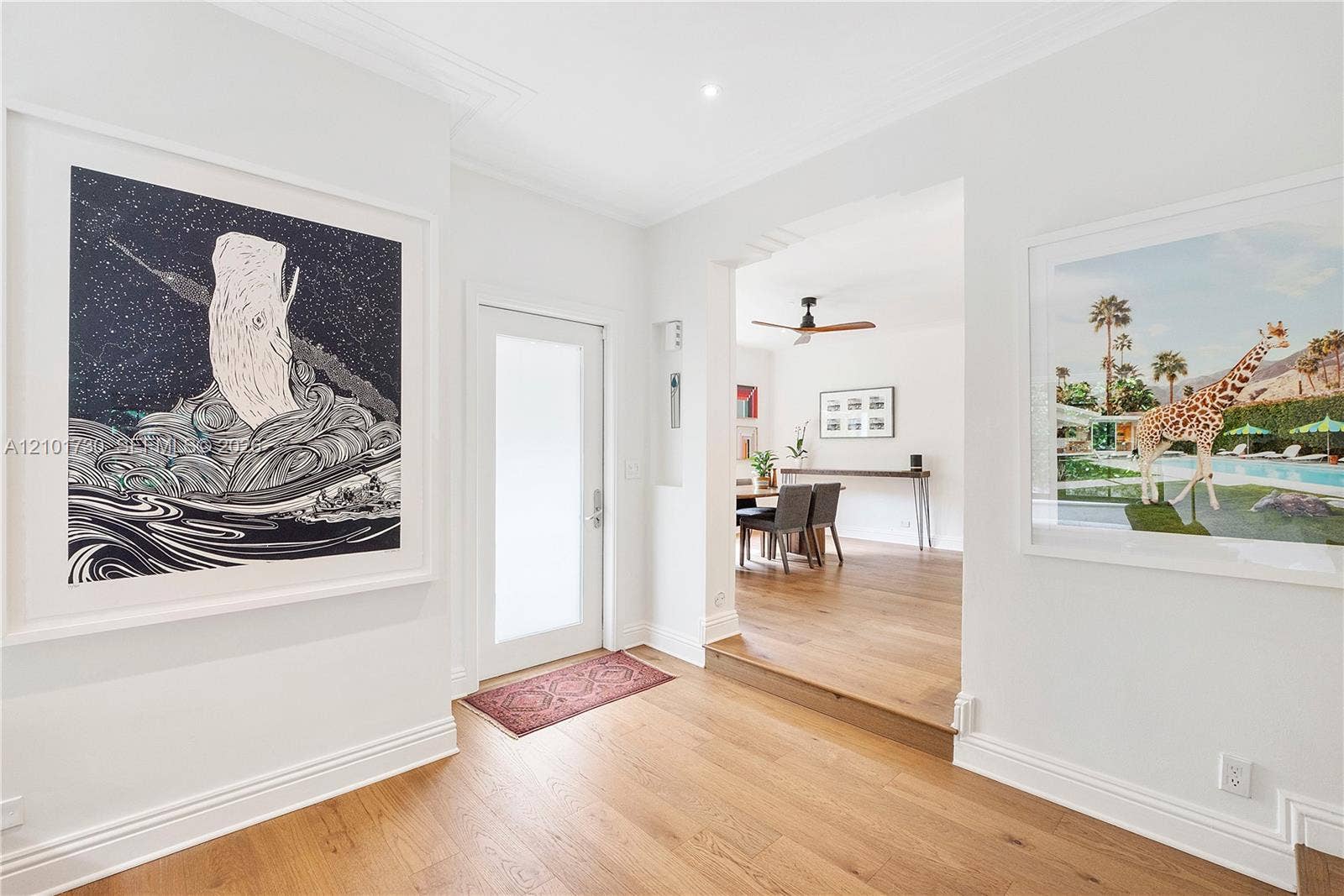435 W 51st Street, Miami Beach, FL 33140 Foyer featuring wood-finish flooring, a recessed entryway with a frosted-glass door, and crown molding