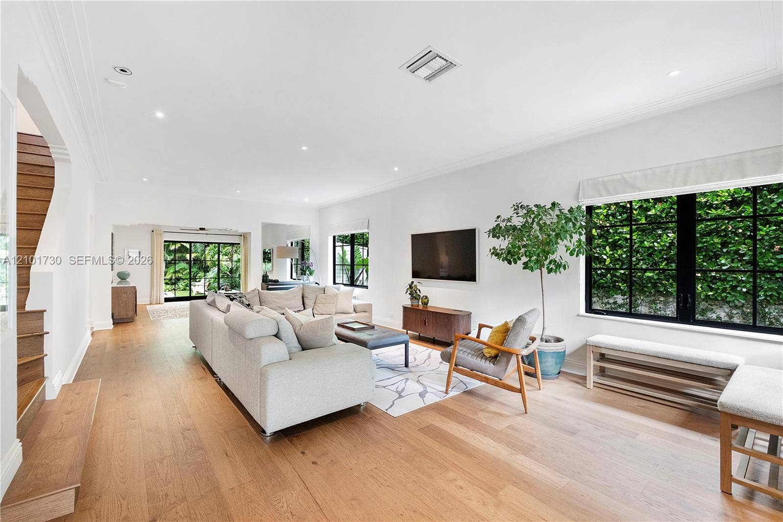 435 W 51st Street, Miami Beach, FL 33140 Living area featuring wood-finish flooring, recessed lighting, crown molding, and large windows with black mullions