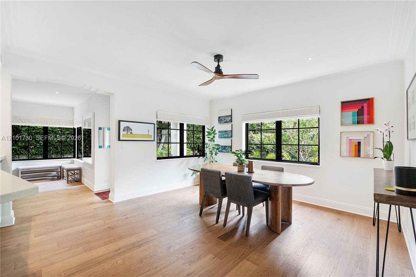 435 W 51st Street, Miami Beach, FL 33140 Dining area featuring wood-finish flooring, multi-pane windows with black frames, recessed ceiling lighting, and a three-blade ceiling fan