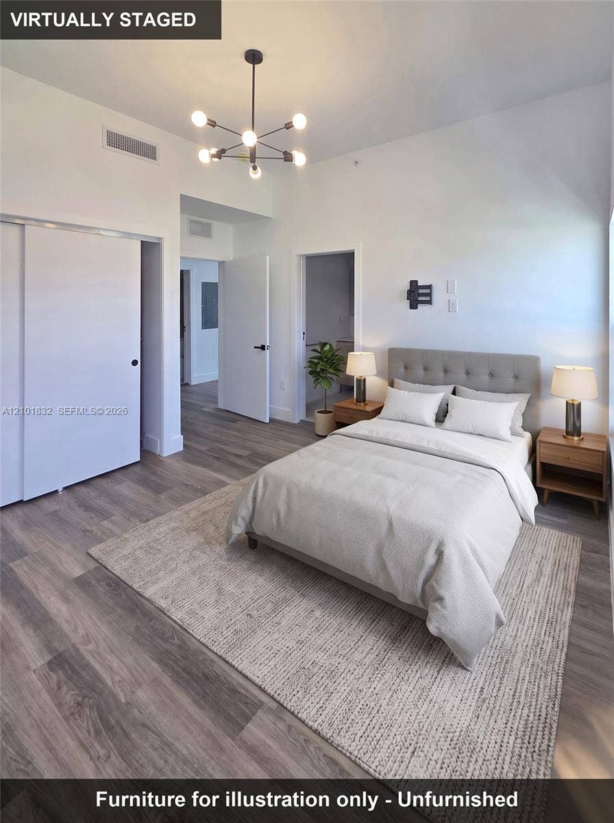 401 Pembroke Road, #201, Hallandale Beach, Hallandale Beach, FL 33009 Wood-finish flooring, multi-arm geometric light fixture, and sliding door closet
