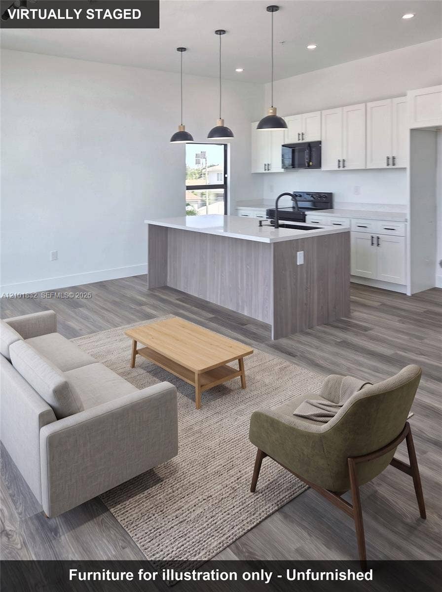401 Pembroke Road, #201, Hallandale Beach, Hallandale Beach, FL 33009 Kitchen featuring white upper cabinetry, a wood-finish island, solid surface countertops, recessed lighting, and three pendant lights