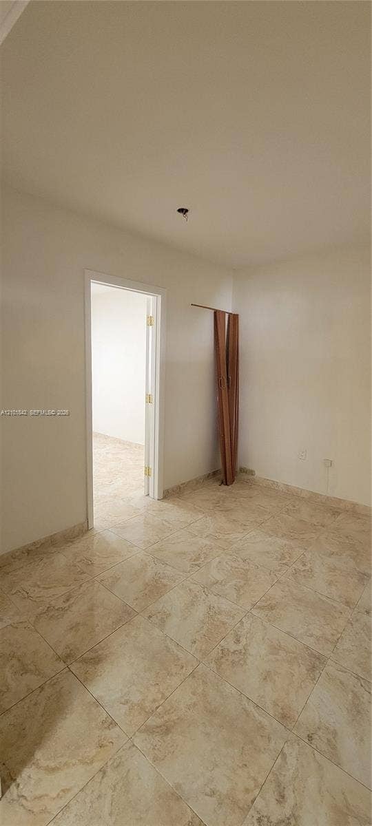 5795 W 13th Court, Hialeah, Hialeah, FL 33012 Neutral-toned stone-finish tile flooring throughout