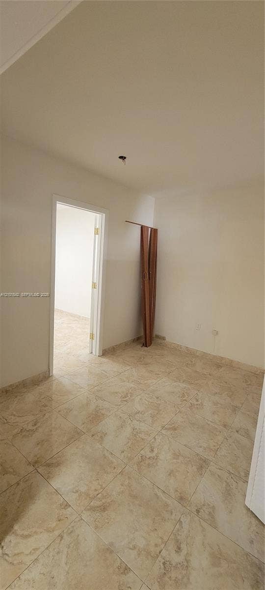 5795 W 13th Court, Hialeah, Hialeah, FL 33012 Neutral-toned tile flooring and white wall finishes