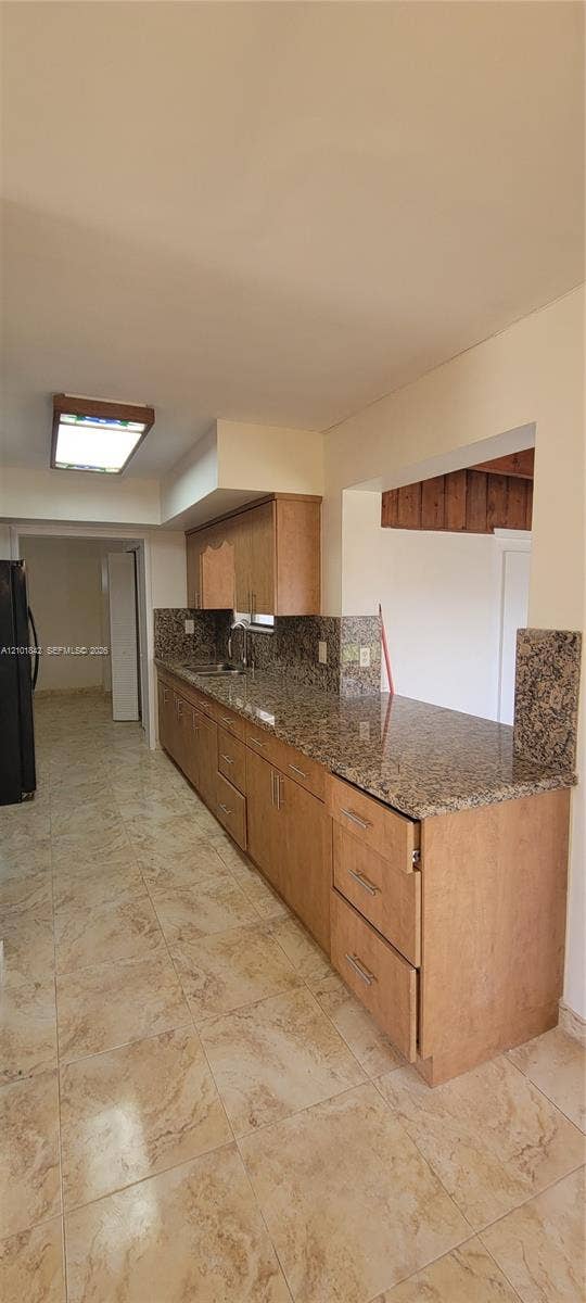 5795 W 13th Court, Hialeah, Hialeah, FL 33012 Kitchen featuring natural wood-finish cabinetry, stone countertops, stone tile flooring, and rectangular flush-mount ceiling lighting