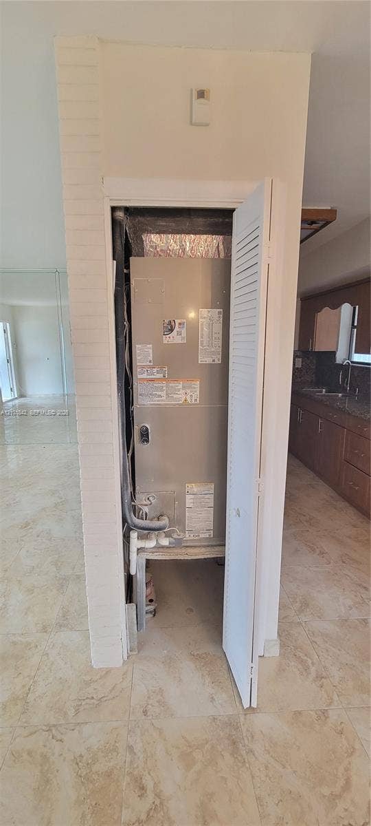 5795 W 13th Court, Hialeah, Hialeah, FL 33012 Dedicated utility closet featuring a metallic HVAC air handler unit and louvered door access