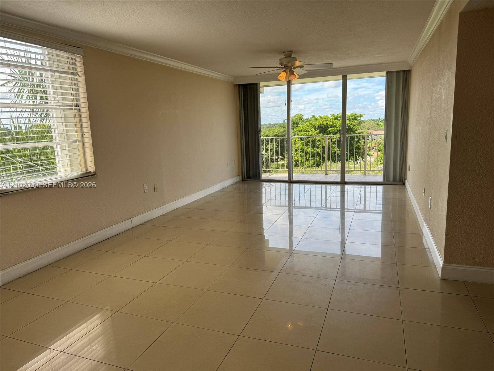 13120 SW 92nd Avenue, #B-PH1, Miami, Miami, FL 33176 Neutral tile flooring, ceiling fan with integrated lighting, oversized sliding glass door, and a private railed balcony