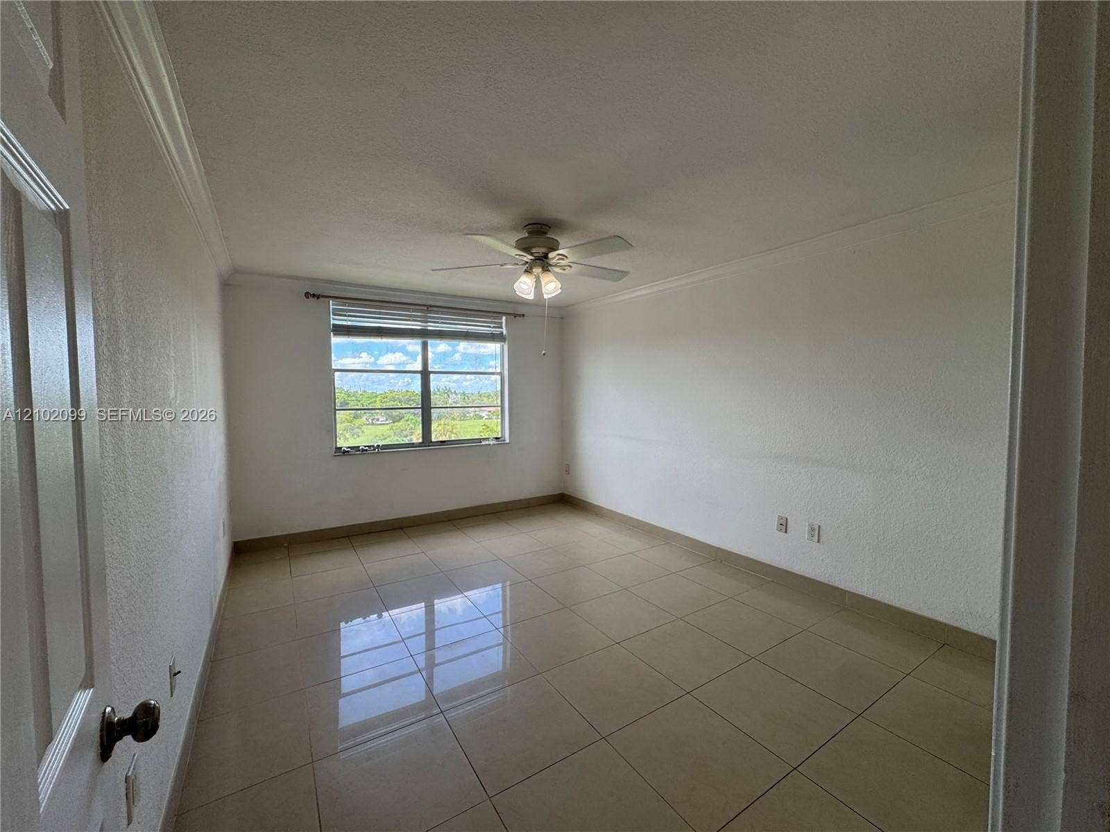 13120 SW 92nd Avenue, #B-PH1, Miami, Miami, FL 33176 Neutral interior featuring polished tile flooring, crown molding, a multi-light ceiling fan, and large window with horizontal blinds
