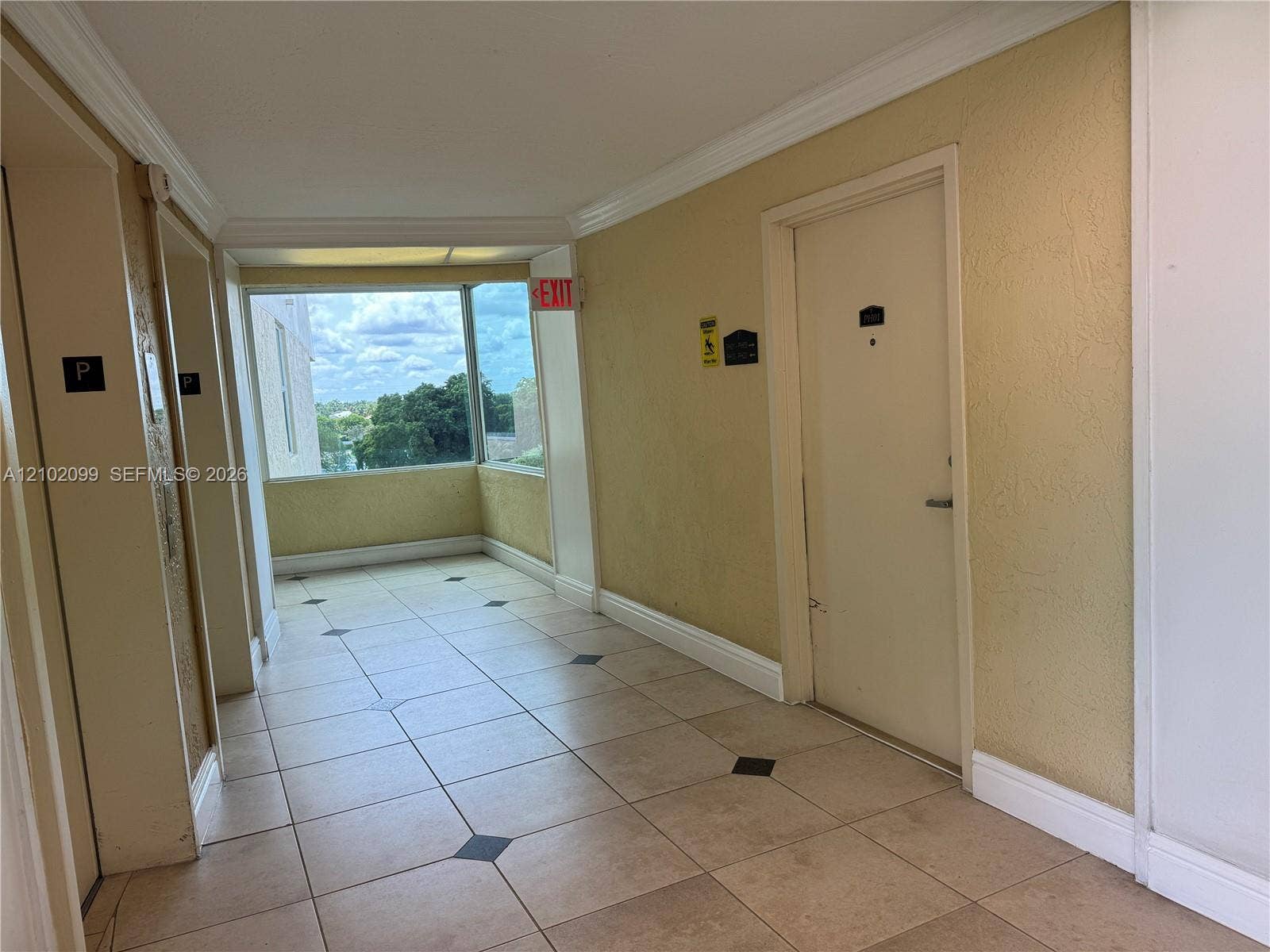 13120 SW 92nd Avenue, #B-PH1, Miami, Miami, FL 33176 Tiled flooring with geometric inlay, crown molding, and floor-to-ceiling windows
