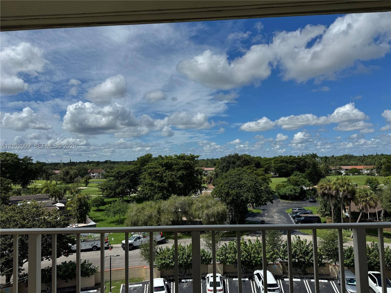 13120 SW 92nd Avenue, #B-PH1, Miami, Miami, FL 33176 Elevated balcony with vertical metal railing overlooking expansive green space and mature trees