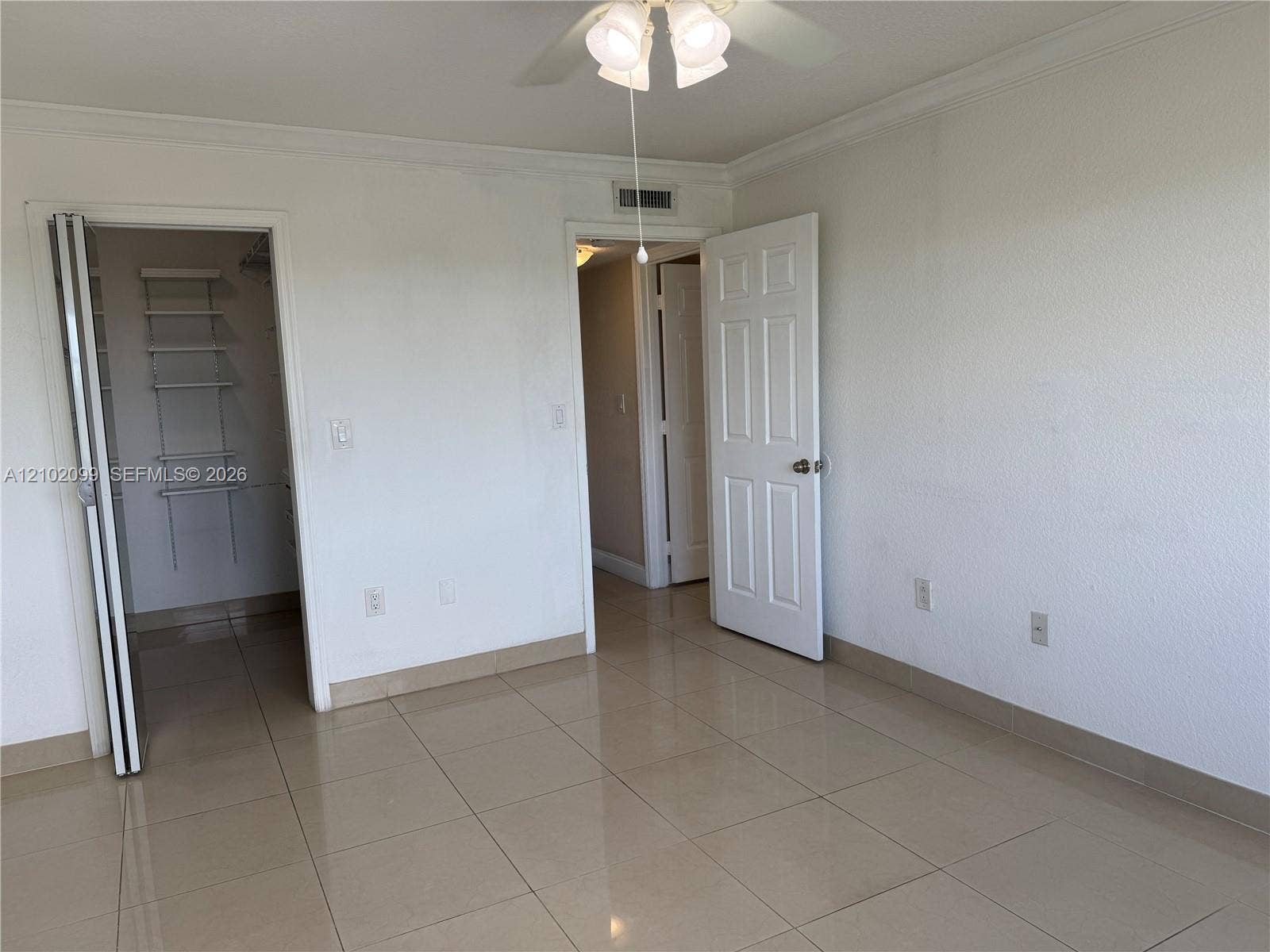 13120 SW 92nd Avenue, #B-PH1, Miami, Miami, FL 33176 Large-format tile flooring, ceiling fan with integrated lighting, and walk-in closet with built-in shelving