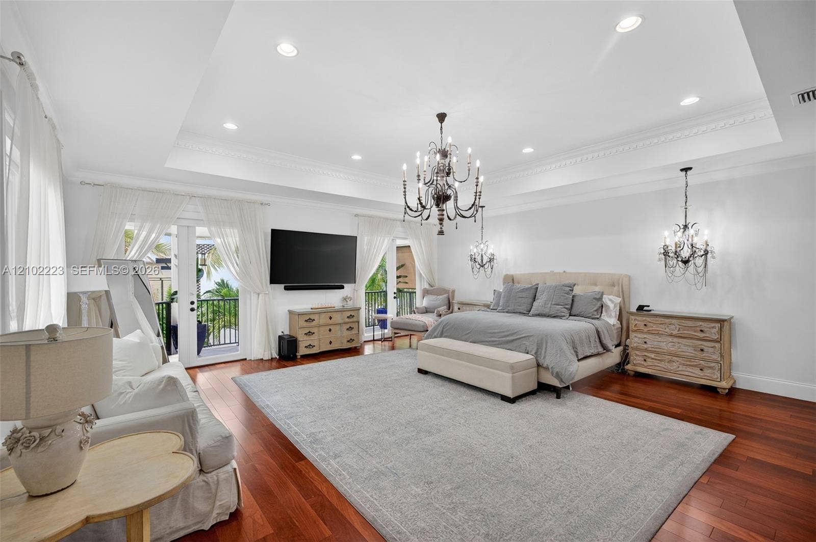 An extraordinary primary suite of truly grand proportions offering a level of space and luxury rarely found this magnificent retreat easily accommodate an expensive private sitting lounge area creating the feeling of a luxurious residence with a residence, soaring tray ceilings, beautiful architectural detail, details, Ridgewood flooring and a private balcony complete the spectacular sanctuary. Undoubtedly one of the most generous proportioned primary suites youll find.