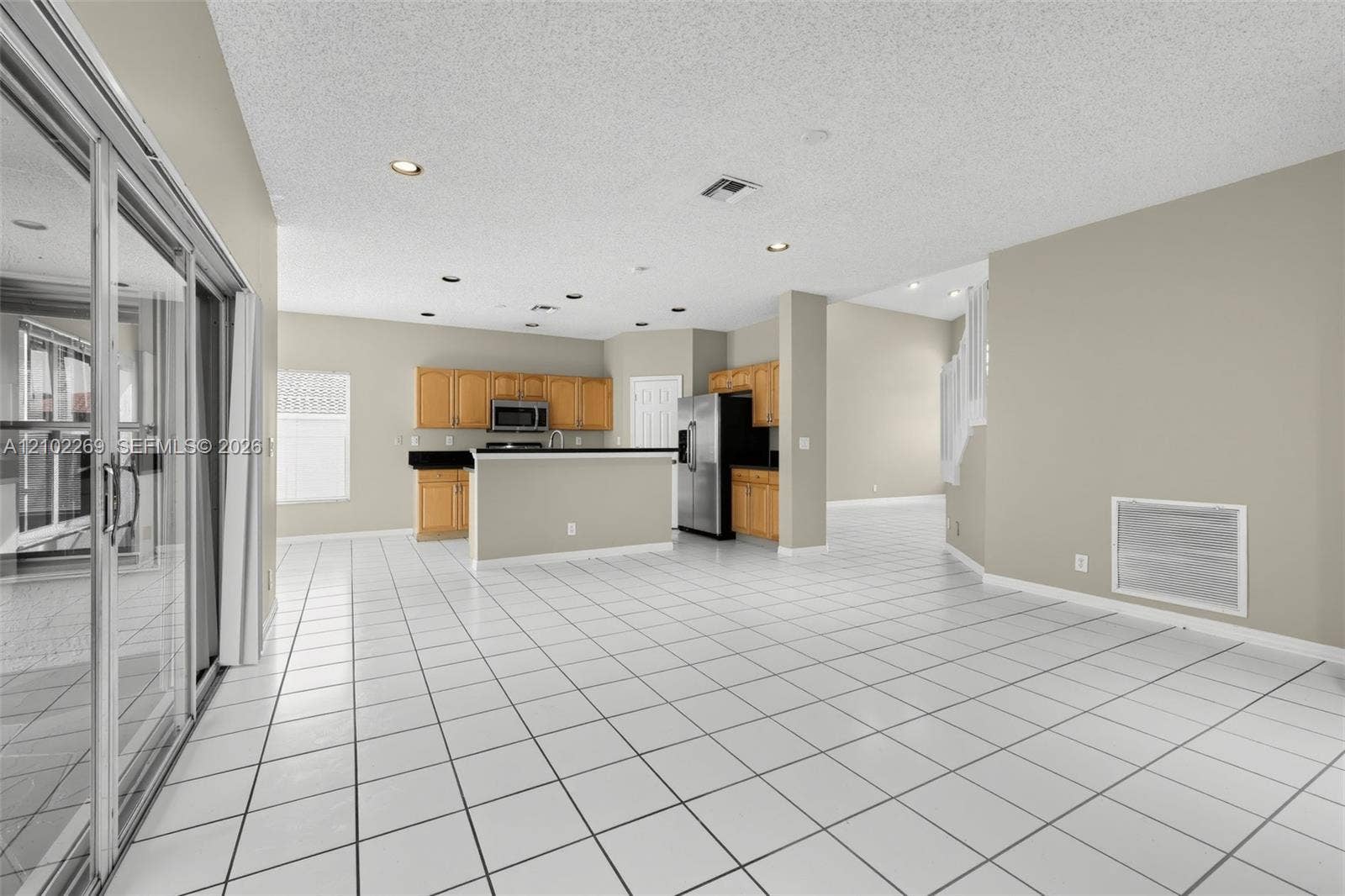 Kitchen featuring wood cabinetry, stainless steel appliances, and a breakfast bar