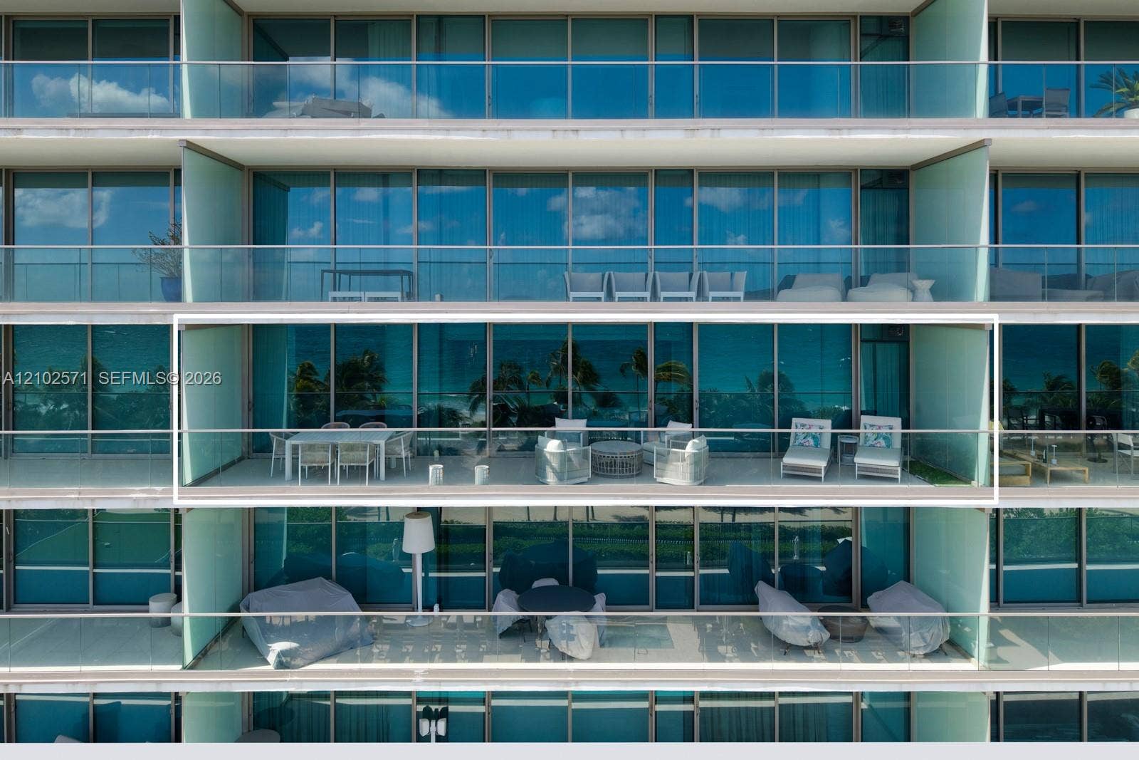 10201 Collins Avenue, #502, Bal Harbour, FL 33154 Expansive balcony featuring floor-to-ceiling glass doors, metal railings, and concrete flooring