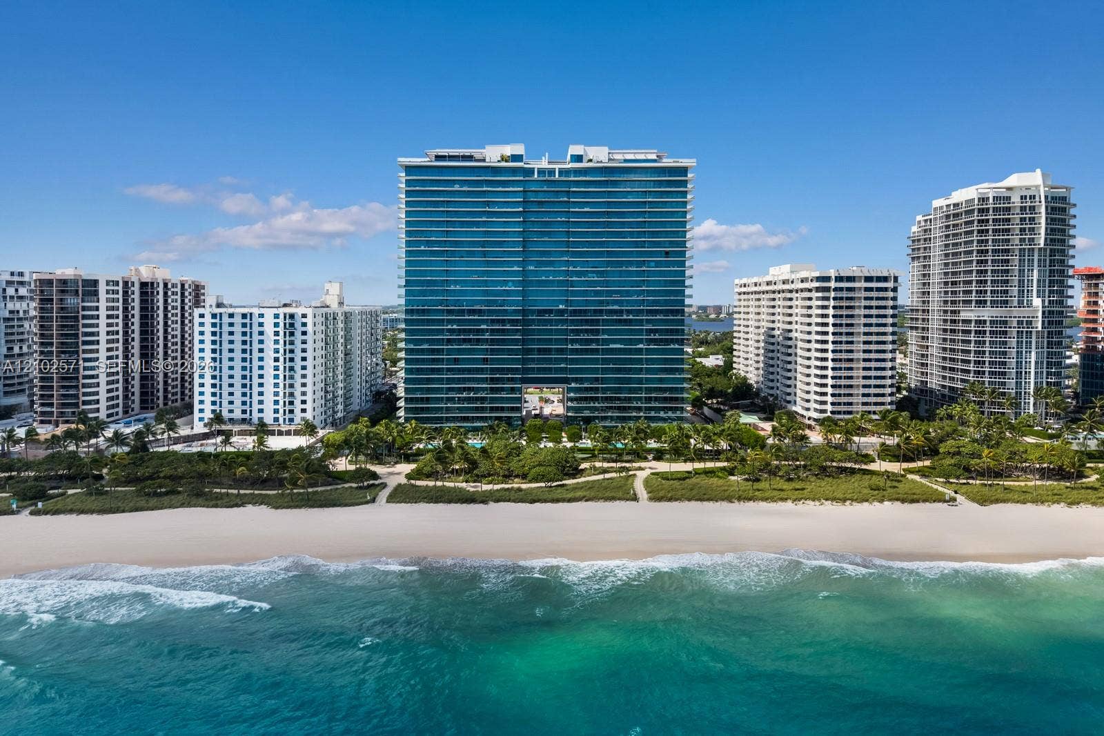 10201 Collins Avenue, #502, Bal Harbour, FL 33154 High-rise residential building featuring floor-to-ceiling glass paneling and direct beach access