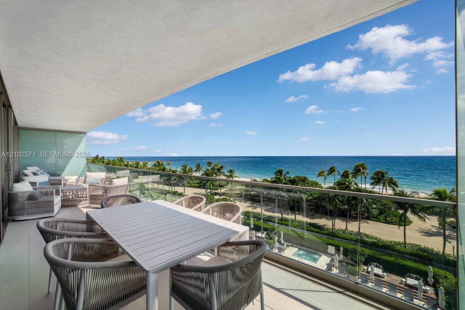 10201 Collins Avenue, #502, Bal Harbour, FL 33154 Covered balcony featuring glass railing panels and tile flooring