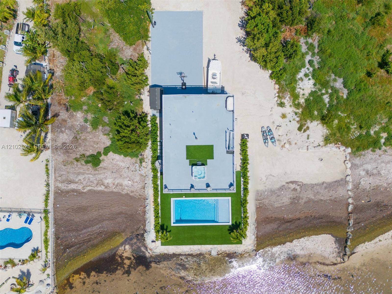 Waterfront property with a private swimming pool, built-in hot tub, and expansive rooftop terrace