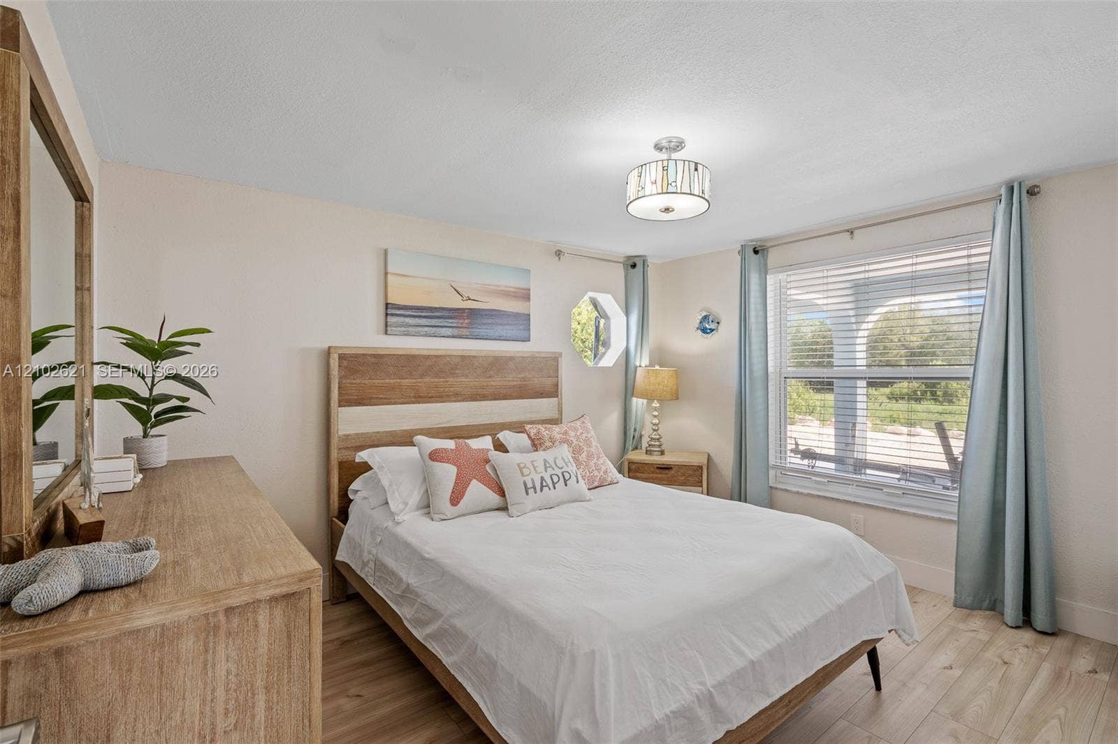 Wood-finish flooring with a multi-pane window and horizontal blinds