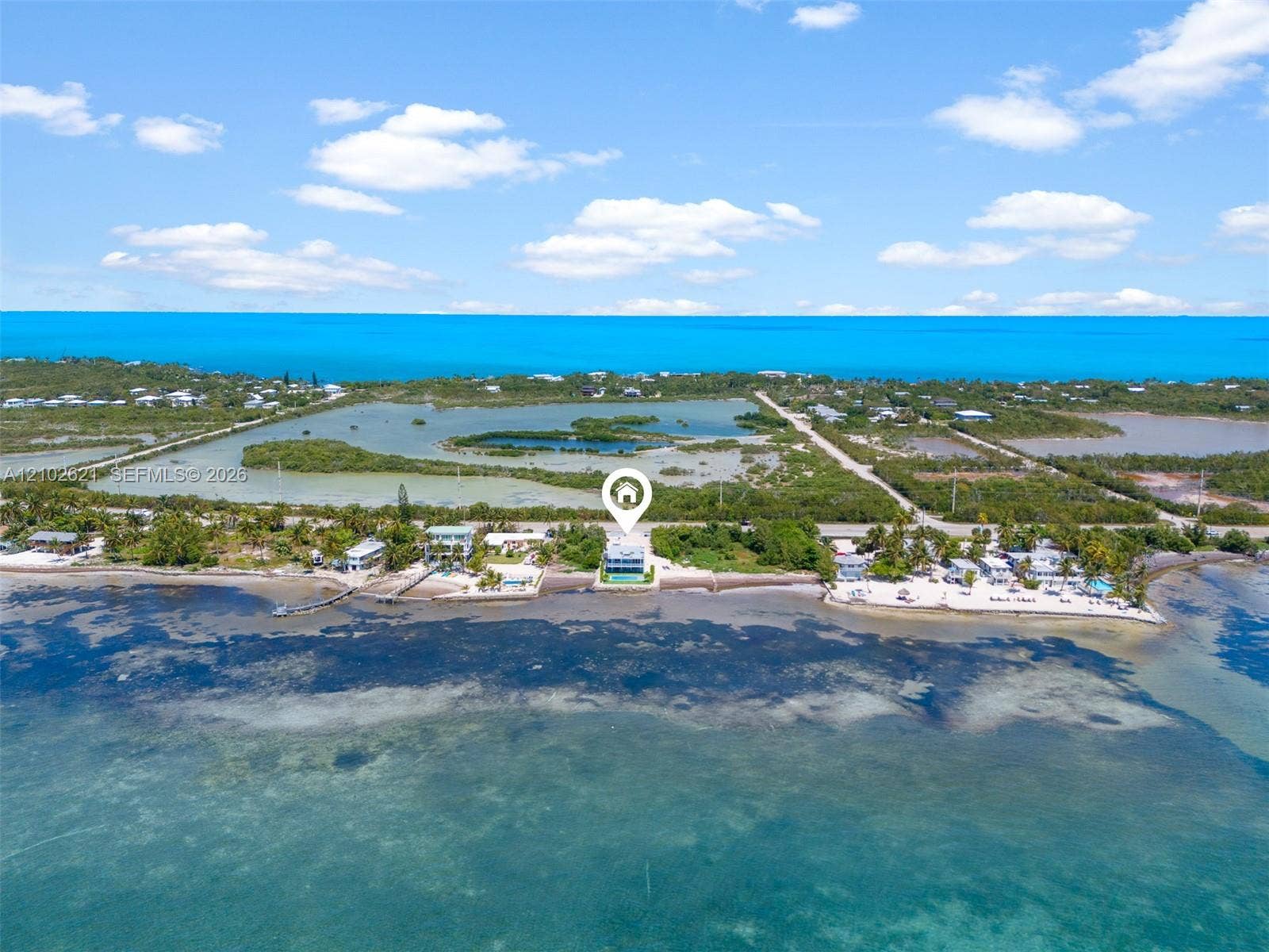 Waterfront property with a private pool, direct ocean access, and a pier