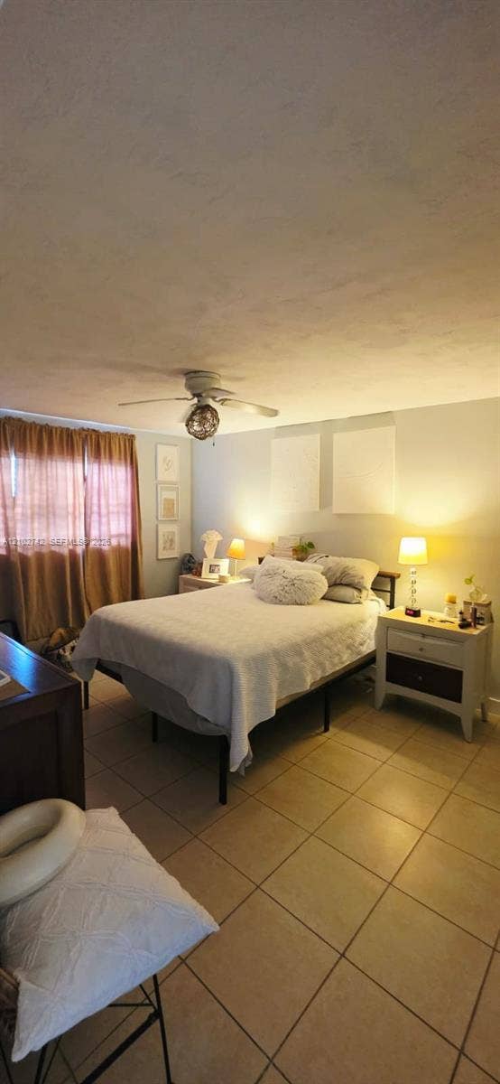 2800 NE 203rd Street, #8, Aventura, FL 33180 Neutral tile flooring, ceiling fan with integrated lighting, and window treatments