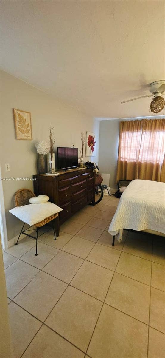2800 NE 203rd Street, #8, Aventura, FL 33180 Neutral ceramic tile flooring and ceiling-mounted light fixture with woven accent