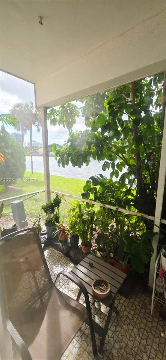 2800 NE 203rd Street, #8, Aventura, FL 33180 Screened-in porch featuring tile flooring and water frontage